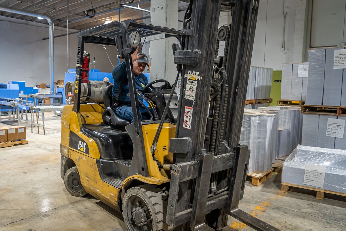 Forklift loading finished work at the Solo Printing facility in Miami