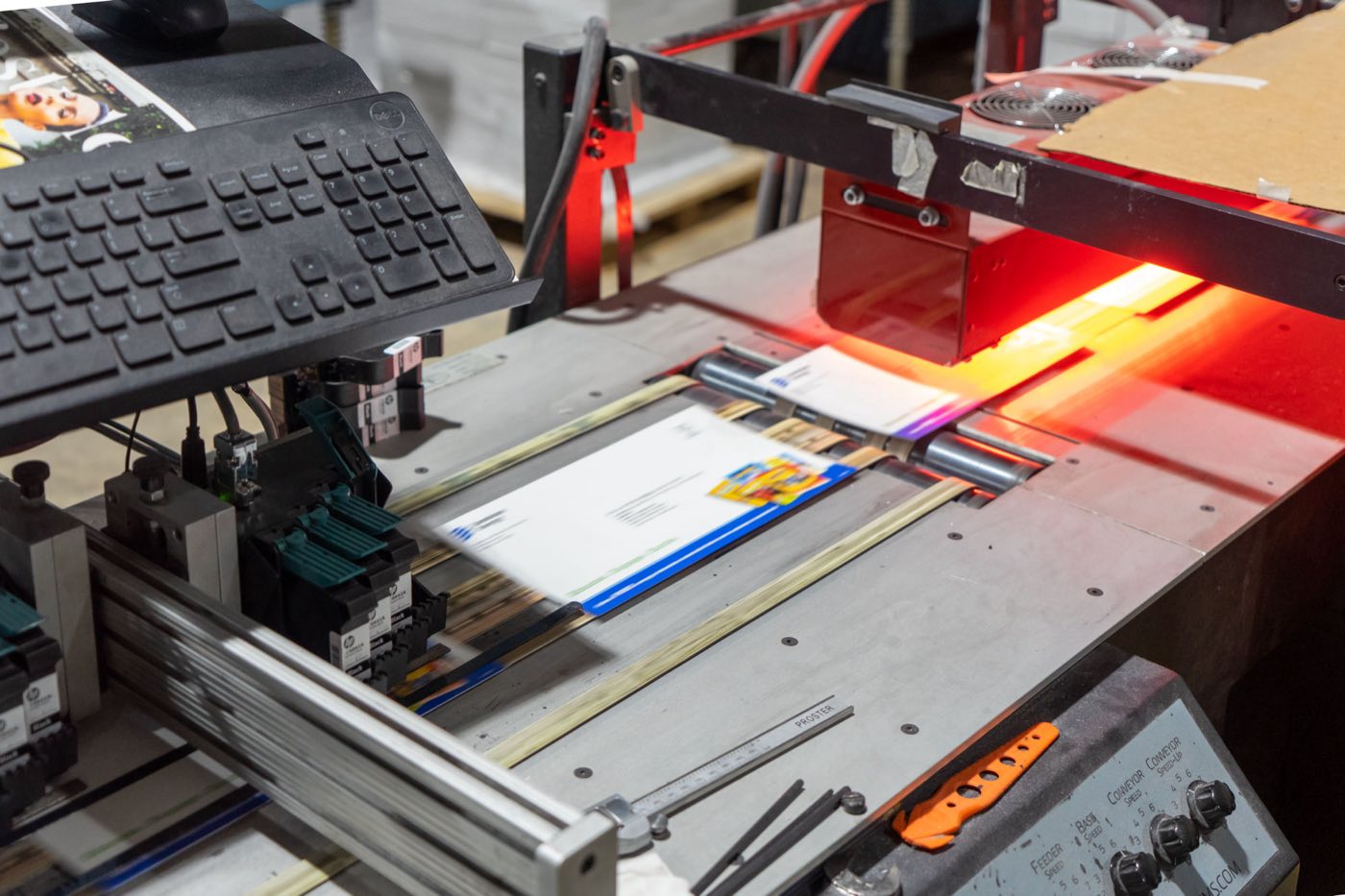 Mail pieces running through the inkjet addressing line in Solo Printing's mailing and fulfillment department in Miami