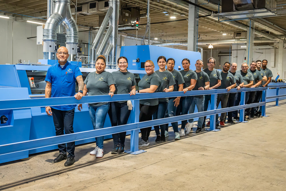 The Solo Printing team gathered together on the plant floor at the Miami facility