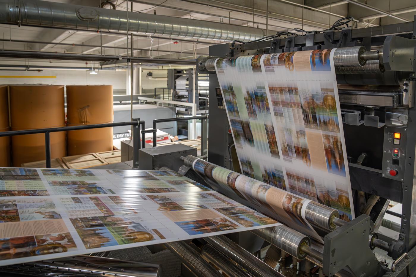 Printed sheets running off the web offset press at Solo Printing in Miami